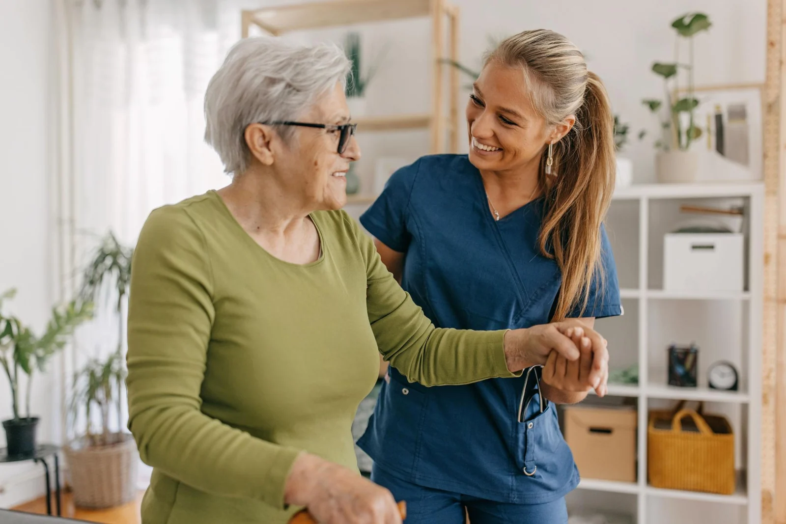A care worker supporting an older adult at home